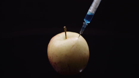 Food-Genetic-Modification-Syringle-Injecting-Liqquid-In-Apple-Gmo-Modification-Concept-2