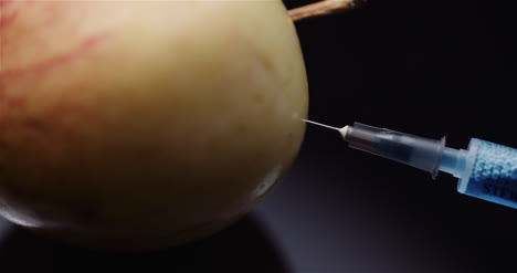 Food-Genetic-Modification-Syringle-Injecting-Liqquid-In-Apple-Gmo-Modification-Concept-4