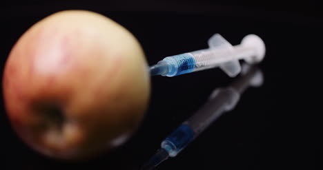 Food-Genetic-Modification-Syringle-Injecting-Liqquid-In-Apple-Gmo-Modification-Concept-5