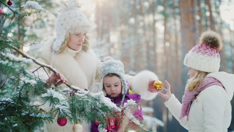 Mom-With-Two-Little-Girls-Preparing-For-Christmas-Decorate-The-New-Year-Tree-With-Round-Balls-In-A-S