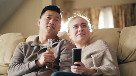 Young-Couple-Watching-Tv-Man-Drinking-Beer