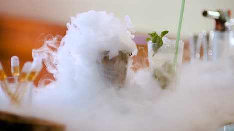 Dry-Ice-In-Glass-While-Bartender-Preparing-Drink