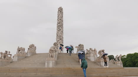 Sculpture-Park-Gustav-Vigeland-Rainy-Weather-A-Lot-Of-Tourists-Walk-Under-The-Umbrellas-In-The-Park