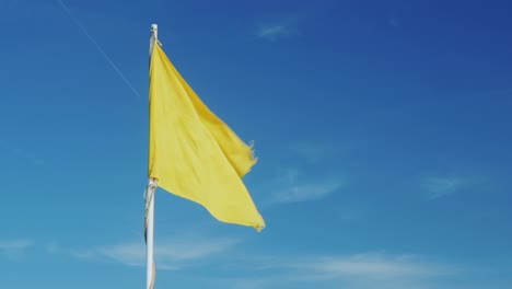 Yellow-Flag-On-A-Background-Of-The-Sky
