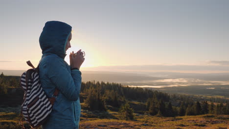 The-Traveler-Drinks-Hot-Tea-On-The-Top-Of-The-Mountain-Admiring-The-Sunrise-On-The-Horizon-Nature-Of