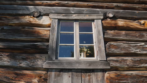 Window-With-Flowers-On-A-Windowsill-In-An-Old-Wooden-House-4k-Video