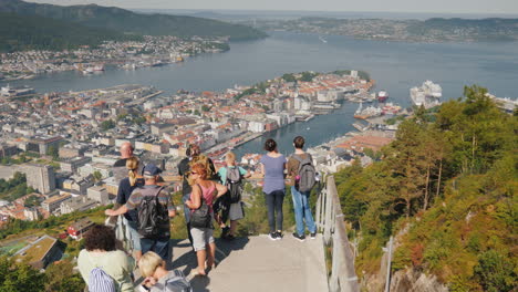 A-Group-Of-Tourists-Admire-The-Beautiful-View-Of-The-City-Of-Bergen-In-Norway-Take-Pictures-Tourism-