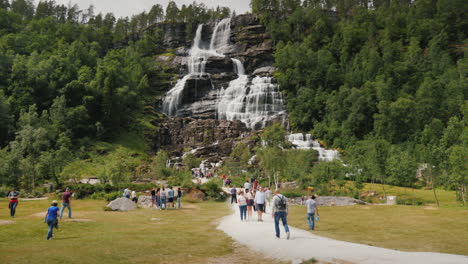 A-Group-Of-Tourists-Walk-Around-The-Highest-Waterfall-In-Norway-According-To-Legend-Water-From-The-W