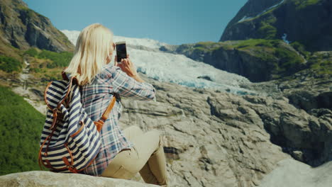 Woman-Tourist-Taking-Pictures-Of-The-Glacier-Traveling-In-Norway-Concept