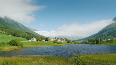 Scenic-Landscape-Of-Norway---Along-The-Lake-There-Is-A-Road-In-The-Background-There-Are-Mountains-4k