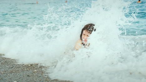 A-Young-Woman-Is-Having-Fun-On-The-Seaside-Sea-Waves-Cover-Her-With-Her-Head
