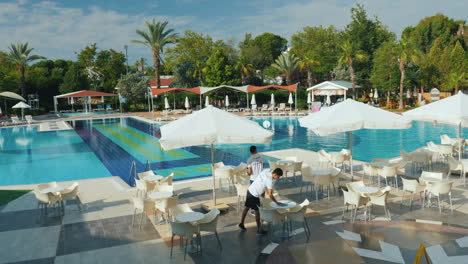 The-Hotel-Staff-Removes-The-Territory-In-A-Five-Star-Hotel-Near-The-Pool-There-Are-Tables-And-Umbrel
