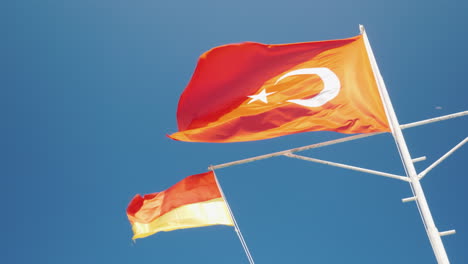 The-Turkish-Flag-And-The-Flag-Of-The-Rescue-Service-Are-Fluttering-Against-The-Blue-Sky-Safe-Rest-Co