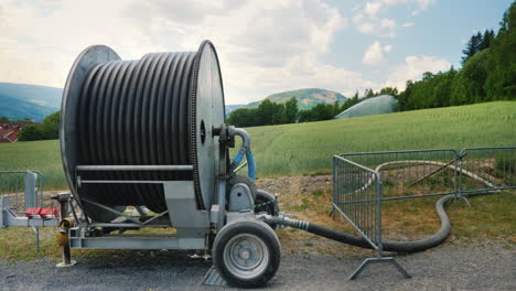 Watering-The-Wheat-Field-In-The-Foreground-Is-A-Large-Coil-With-A-Water-Hose-Agriculture-In-Norway-4