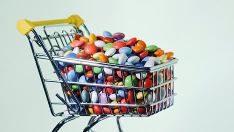 Sweets-In-A-Shopping-Trolley-On-A-Black-Background-4k-Video