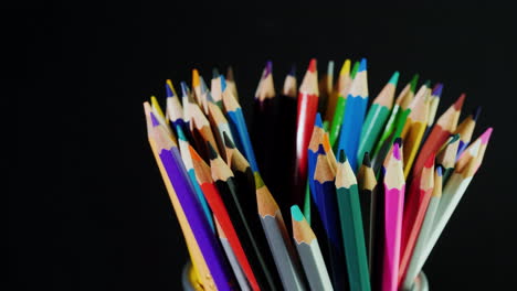 A-Set-Of-Multi-Colored-Pencils-On-A-Black-Background