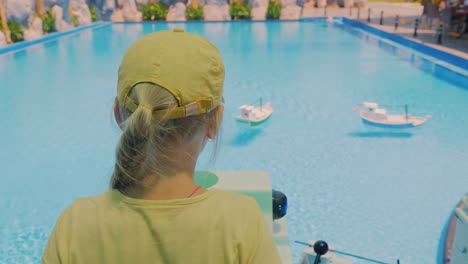 Girl-Playing-On-A-Toy-Boat-Ride-Control-Which-Float-In-The-Pool-4k-Video