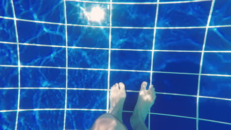 Men's-Feet-At-The-Bottom-Of-The-Pool