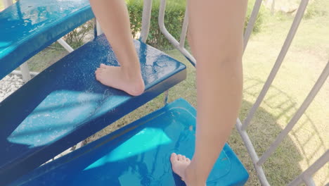 Legs-Climbing-Up-The-Stairs-On-The-Water-Slide-In-The-Water-Park