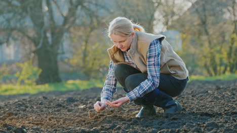 A-Woman-Farmer-Planting-Seeds-In-His-Garden-Spring-Work