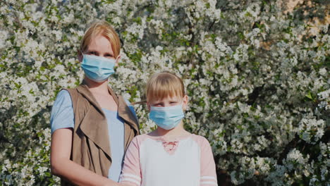 Woman-With-Children-In-Gauze-Bandages-Against-The-Background-Of-Flowering-Trees-Allergy-Problems-In-