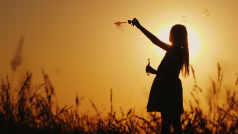 Carefree-Kid-Playing-With-Soap-Bubbles-At-Sunset-Summer-And-Happy-Childhood-Concept