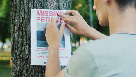 A-Young-Man-Puts-Up-Ads-For-A-Missing-Person-In-The-Park