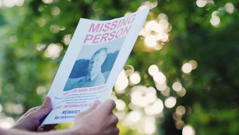 Man-Holding-A-Flyer-With-The-Announcement-Of-The-Missing-Man
