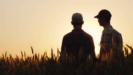 Two-Young-Men-Hugging-Against-The-Backdrop-Of-The-Sunset-Looking-Forward-To-The-Horizon