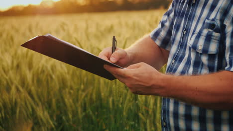 The-Farmer-Signs-The-Document-And-Shakes-Hands-With-A-Partner-On-The-Background-Of-A-Wheat-Field