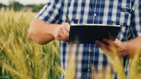 The-Farmer-Signs-The-Document-And-Shakes-Hands-With-A-Partner-On-The-Background-Of-A-Wheat-Field