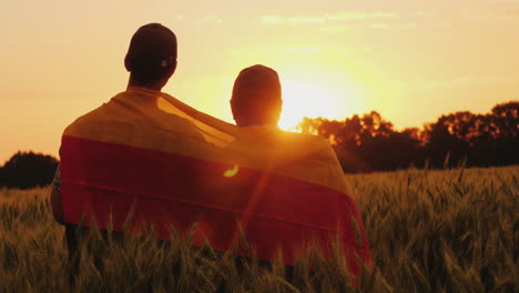 Two-Men-With-The-Flag-Of-Germany-Behind-Their-Shoulders-Are-In-A-Picturesque-Place-In-A-Field-Of-Whe