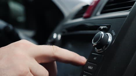 Male-Hand-Adjusts-The-Tuning-Of-The-Car-Radio-Close-Up-Shot