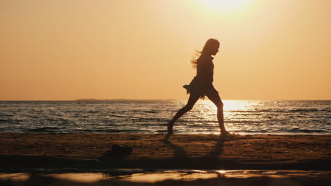 Silhouette-Of-A-Carefree-Child-Running-Along-The-Beach