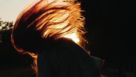 Silhouette-Of-A-Girl-With-Long-Hair-Shakes-His-Head-And-Plays-With-His-Hair-In-The-Sun