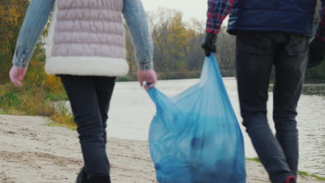 Children-Volunteers-Carry-A-Bag-Of-Garbage-Go-Along-The-Shore-Of-The-Lake-Where-They-Collected-Waste