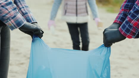 Child-Volunteer-Collects-Trash-In-The-Park-Smiling-At-The-Camera