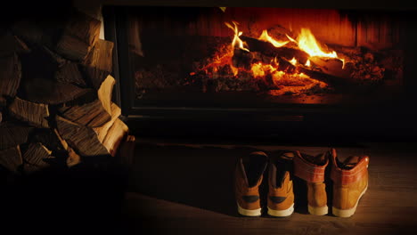 Men's-And-Women's-Winter-Boots-Dry-Near-The-Fireplace-Romantic-Winter-Evening