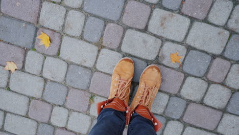 Feet-In-Autumn-Boots-On-The-Sidewalk-The-Camera-Rotates