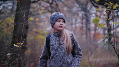 A-Little-Girl-Walks-Through-The-Woods-At-Dusk-A-Child-Lost-In-The-Woods