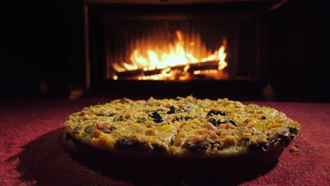 A-Group-Of-People-Takes-A-Slice-Of-Pizza-Delicious-Pizza-By-The-Fireplace