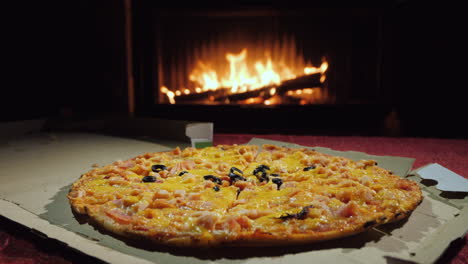 A-Tasty-Pizza-Is-Taken-Piece-By-Piece-A-Group-Of-People-Dinner-By-The-Fireplace