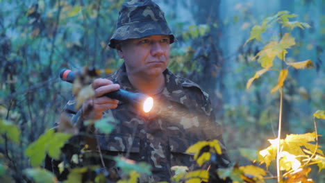 A-Man-Shines-A-Flashlight-At-Dusk-In-The-Forest-Search-Operation