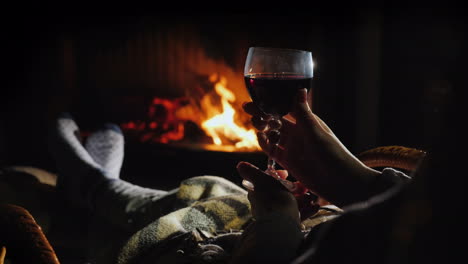 An-Evening-Alone-By-The-Fireplace-With-A-Glass-Of-Wine---Escape-From-Everything-Concept