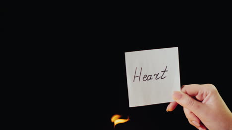 Man-Burns-A-Paper-With-The-Inscription-Heart