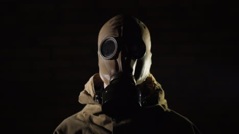 A-Man-In-A-Protective-Suit-And-Gas-Mask-Smoke-In-The-Foreground