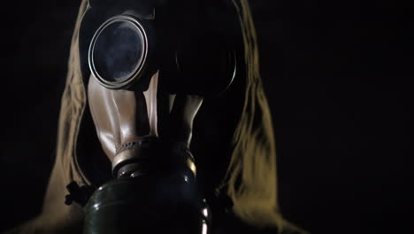 A-Man-In-A-Protective-Suit-And-Gas-Mask-Smoke-In-The-Foreground