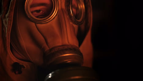 A-Man-In-A-Gas-Mask-Looks-At-The-Fire-The-Flame-Is-Reflected-In-The-Mask