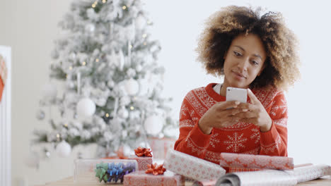 Young-woman-checking-for-Xmas-messages