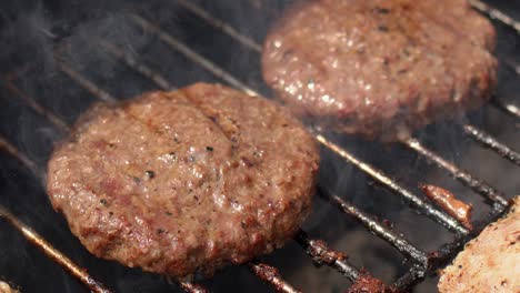 Tasty-two-hamburger-meat-frying-on-smoking-hot-barbecue--Slow-motion-video